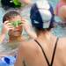 A Buhr Park Shark swimmer adjusts his goggles during a swimathon to raise funds for Ann Arbor Active Against ALS and Bob Schoeni at the Buhr Park Pool on Wednesday morning. Melanie Maxwell | AnnArbor.com